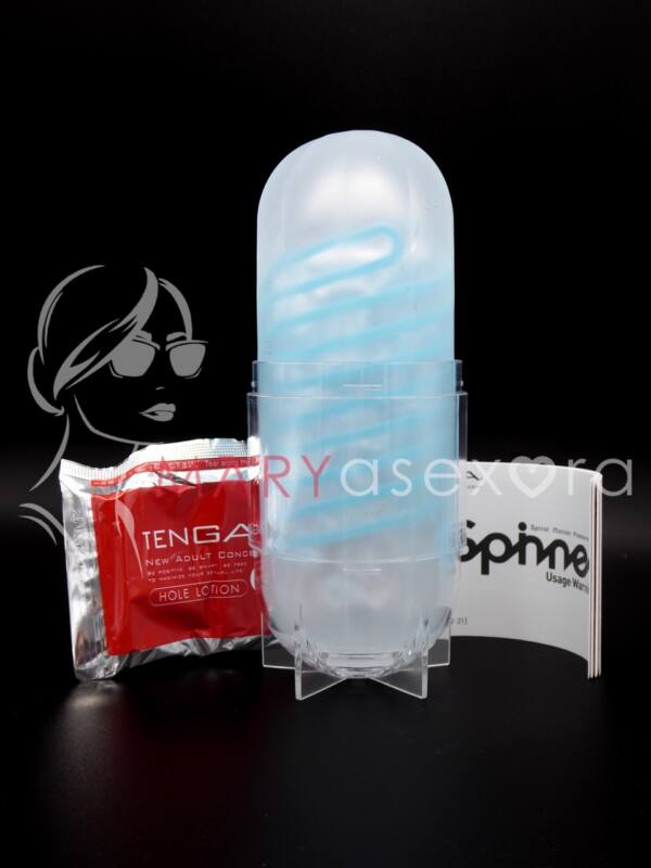 Tenga Spinner Tetra 01 - Contenido mostrando sobre de lubricante, manual y manga masturbadora con soporte para secado